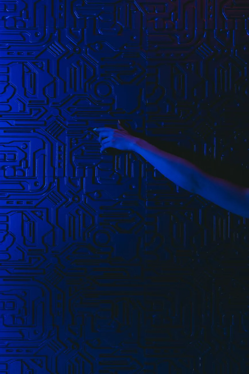 A human hand reaching toward a glowing blue circuit-patterned wall