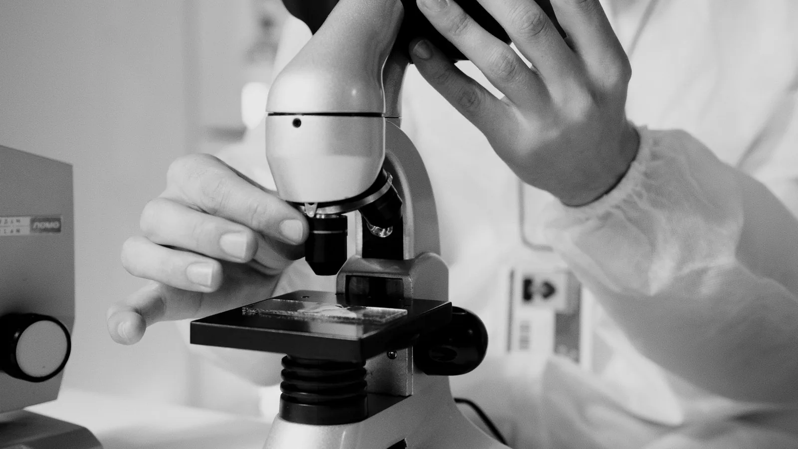 A scientist examining samples through a microscope in a modern laboratory